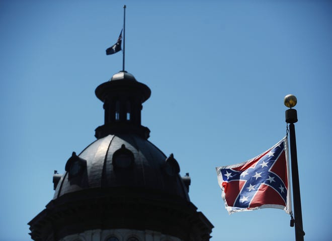 FILE - In this June 19, 2015 file photo, the Confederate flag flies near the South Carolina Statehouse in Columbia, S.C. The General Assembly returns Monday, July 6, 2015, to discuss what to do with the rebel flag that has flown over some part of the Statehouse for more than 50 years. (AP Photo/Rainier Ehrhardt, File)