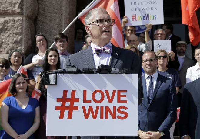 In this June 29, 2015 photo, Jim Obergefell, the named plaintiff in the Obergefell v. Hodges Supreme Court case that legalized same sex marriage nationwide, is backed by supporters of the courts ruling on same-sex marriage on the step of the Texas Capitol during a rally in Austin, Texas. The Supreme Court declared that same-sex couples have a right to marry anywhere in the United States. It was 2004 when Massachusetts became the first state to allow same-sex couples to marry. Eleven years later, the Supreme Court has now ruled that all those gay marriage bans must fall and same-sex couples have the same right to marry under the Constitution as everyone else. (AP Photo/Eric Gay)