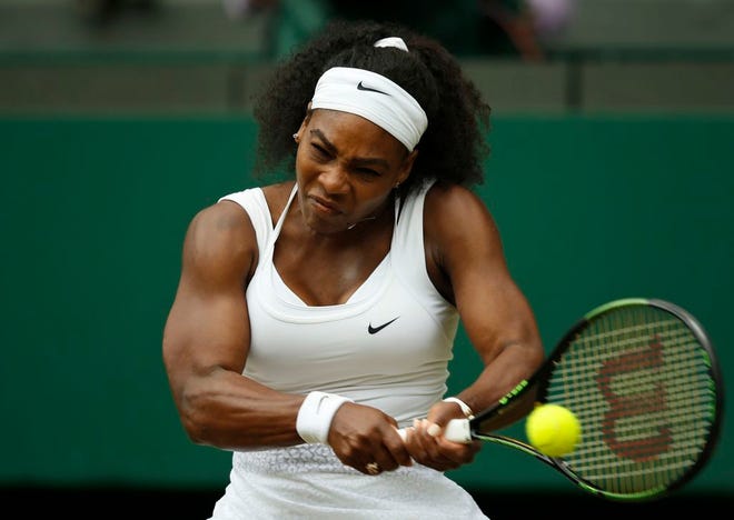 Serena Williams of the United States makes a return to Venus Williams of the United States, during their singles match against at the All England Lawn Tennis Championships in Wimbledon, London, Monday July 6, 2015.