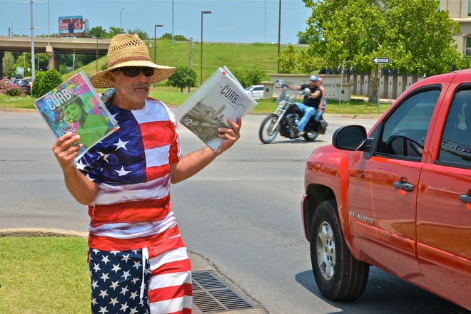 Calvin McCraw, of Oklahoma City, dressed in patriotic colors, sells the "Curbside Chronicle" at Northwest Expressway and Classen last July. [The Oklahoman Archives]
