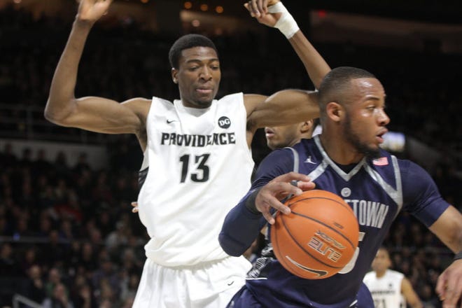 Paschal Chukwu, who has since left Providence College, guards Georgetown's Jabril Trawick last season.