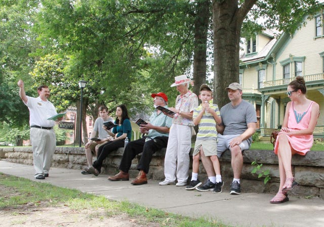 JAMIE MITCHELL • TIMES RECORD Stephen Christian, left, leads a walking tour through one of Arkansas’ oldest neighborhoods, the Fort Smith’s Belle Grove Historic District, Sunday, July 05, 2015, beginning at the historic Clayton House. The walking tour covers a variety of Victorian architectural styles and stories of the people who built the residences. A booklet for each attendee lists architectural and date information for each house and participants receive a complimentary map of the district and are able to take home the limited-edition booklet for a donation of $15 towards the continued maintenance and preservation of the Clayton House.

 Learn early Fort Smith history in this enjoyable way through the stories (and some myths) about the bankers, saloon owners, cotton merchants, railroad conductors and more who lived in these irreplaceable historic structures. The tour begins in the Clayton House front yard at 2:30 and covers up to 12 blocks. 
 JAMIE MITCHELL • TIMES RECORD Stephen Christian, left, leads a walking tour through one of Arkansas’ oldest neighborhoods, the Fort Smith’s Belle Grove Historic District, Sunday, July 05, 2015, beginning at the historic Clayton House. The walking tour covers a variety of Victorian architectural styles and stories of the people who built the residences. A booklet for each attendee lists architectural and date information for each house and participants receive a complimentary map of the district and are able to take home the limited-edition booklet for a donation of $15 towards the continued maintenance and preservation of the Clayton House.The cost is $5. For more information, call the Clayton House at 479-783-3000.