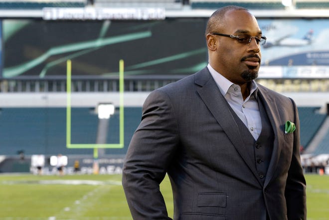 FILE - In this Sept. 19, 2013, file photo, former Philadelphia Eagles quarterback Donovan McNabb pauses during a television interview before an NFL football game against the Kansas City Chiefs, in Philadelphia. McNabb has been arrested again in Arizona on suspicion of driving while under the influence. Police in the Phoenix suburb of Gilbert said Tuesday, July 7, 2015, that McNabb was cited and released from a police facility after being arrested June 28, 2015, following a non-injury collision late that night. (AP Photo/Julio Cortez, File)