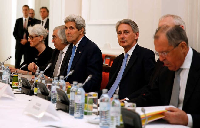 U.S. Secretary of State John Kerry, third left, British Foreign Secretary Philip Hammond, second right, and Russian Foreign Minister Sergey Lavrov, right, meet with foreign ministers from China, Germany and France at a hotel in Vienna, Austria, on Monday, July 6. Iran's foreign minister said on Monday some differences still remained between Iran and six powers over the country's disputed nuclear programme ahead of Tuesday's deadline for a final agreement to end a 12-year-old dispute.
