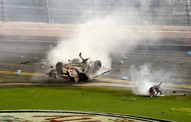 Austin Dillon tumbles down the front stretch as his engine lands in the infield after he was involved in a multi-car crash on the final lap of a NASCAR Sprint Cup series auto race at Daytona International Speedway, Monday, July 6, 2015, in Daytona Beach, Fla. (AP Photo/Terry Renna)