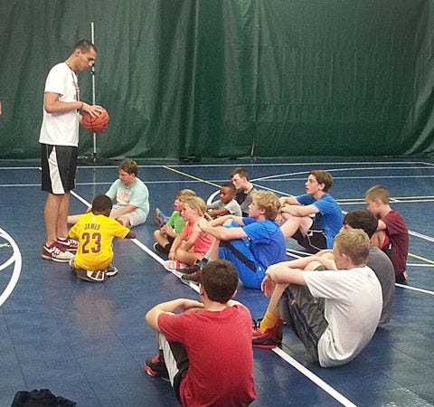 Former Virginia Tech basketball player Christian Beyer, left, talks to camp participants during a basketball camp at Sports Nation of New Bern Tuesday. Beyer, a New Bern native, started as a walk on but earned a scholarship during his senior season with the Hokies this past winter.