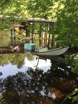 Shifting tides stranded a Rhode Island pair and their slippery sushi harvest along the Taunton River on Sunday. An eel fisherman and his grandson were forced to jump from their boat as took on water near a railroad trestle.