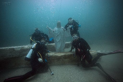 The reef-building company TISIRI this year created an artificial reef featuring a concrete statue of Jesus about 12 miles off Ponte Vedra. The reef was built in memory of John Leone, who died at 19 after a hit-and-run accident on Gate Parkway. Shown are Leone family friend Ed Dendor (back left), father Jack Leone (back right) daughters Elizabeth Leone (front left) and Emily Leone (front right).