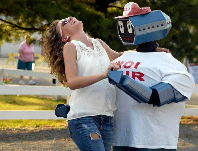 In this Journal Star file photo from 2012, Samantha Buckley of Washington gets swept off her feet as she shares a romantic moment with Oscar the Robot at the Heart of Illinois Fair.