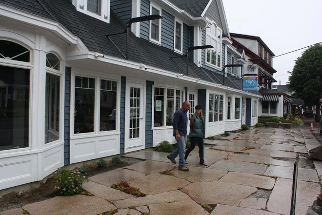 Just days before the shops at 254 Main Street in Ogunquit officially opened for the season, builder Dave Hill of Wells and his office manager, Kristen Brown, check over the new space.

Courtesy photo