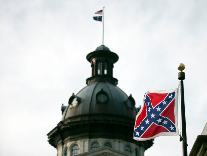 A Confederate battle flag flies in front of the South Carolina statehouse Wednesday, July 8, 2015, in Columbia, S.C. The House is expected to debate a measure Wednesday that would remove the flag from the Capitol grounds. (AP Photo/John Bazemore)
