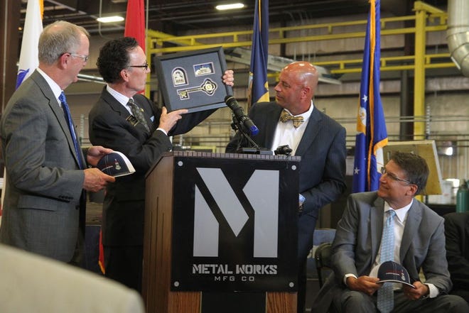 The new president of Ultra Machine and Fabrication Phillips Sykes receives a key to city from Shelby Mayor Stan Anthony during the July 1 announcement of the company's expansion. Man Lift Manufacturing Co.'s move to Shelby is part of the expansion process.
