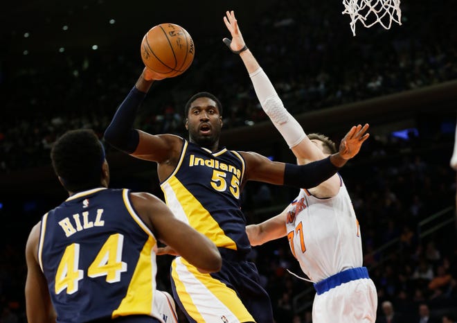 Indiana Pacers' Roy Hibbert (55) passes the ball to teammate Solomon Hill (44) as New York Knicks' Andrea Bargnani (77) defends during the second half of an NBA basketball game Wednesday, April 8, 2015, in New York. (AP Photo/Frank Franklin II)