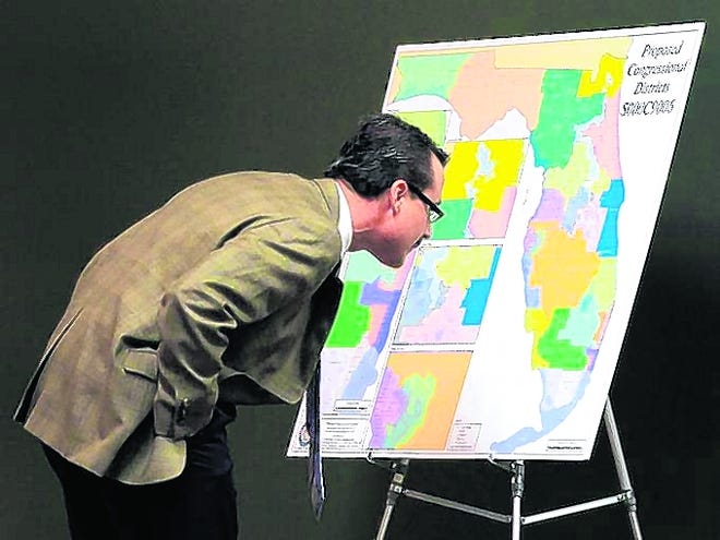 Florida Sen. Rene Garcia, R-Hialeah, looks at a map of proposed changes in 
congressional districts during a January 2012 Senate committee meeting on 
reapportionment in Tallahassee. A judge this year rejected a version of the 
map. AP PHOTO / 2012
