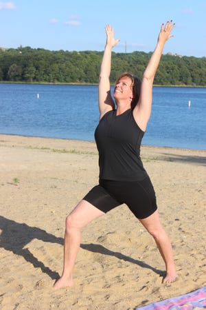 SPECTATOR PHOTOS BY GEORGE AUSTIN

DIane Rodrigues leads students in her yoga class at Pierce Beach Park recently.
