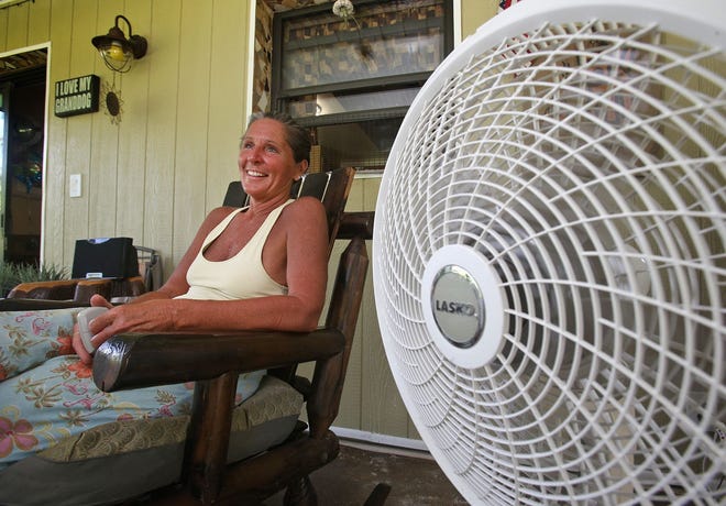 Judy Hallock keeps cool with the aid of a fan while living without air conditioning in her New Smyrna Beach home. News-Journal/Nigel Cook