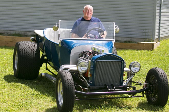 Ed Watkins sits on his 1923 Ford T-Bucket replica at his home. Watkins performed many of the customizations on the project, which has a 1962 Chevy V-8 engine.