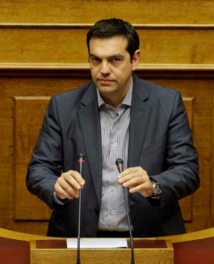 Greece's Prime Minister Alexis Tsipras prepares to speaks during a parliament meeting in Athens, Saturday, July 11, 2015. Lawmakers have been summoned to emergency sessions in parliament after Prime Minister Alexis Tsipras sought authorization to negotiate a new bailout deal with European creditors. (AP Photo/Thanassis Stavrakis)