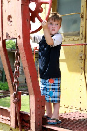 JAMIE MITCHELL • TIMES RECORD Dax Snow, 4, tries his hand as a train brakeman, Friday, July 10, 2015, while spending the day with his mother, Heather Snow, taking in the sites and activities in downtown Fort Smith.