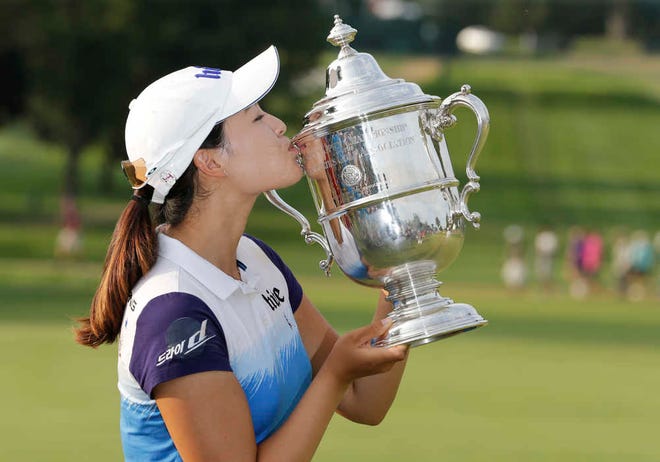 South Korea's In Gee Chun kisses the championship trophy after winning the U.S. Women's Open golf tournament at Lancaster Country Club on Sunday in Lancaster, Pa. Chun won by one stroke over second-place finisher Amy Yang.