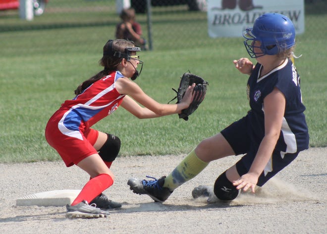 Rochester's Alicia Beatty, left, waits to put the tag on Somersworth's Lily Meekins during Sunday's 10U state championship game in Rochester. AL PIKE/FOSTERS.COM