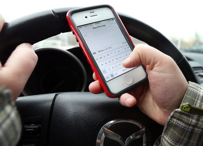 Seacoast police officers may differ on whether they have issued citations or warnings related to New Hampshire's new hands-free driving law, but they agree talking while driving has decreased since the law went into effect July 1. Ioanna Raptis photo illustration