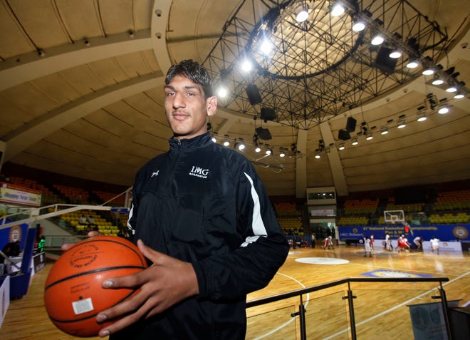 In this Jan. 2, 2011, file photo, Indian teenager Satnam Singh poses with a basketball at the Talkatora Stadium in New Delhi, India. At 7-foot-2 and nearly 300 pounds, the Dallas Mavericks made Singh the NBA's first Indian-born draft pick and believe he can have a future in the NBA.