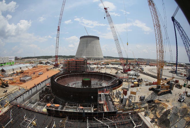 FILE- In this June 13, 2014 file photo, construction continues on a new nuclear reactor at Plant Vogtle power plant in Waynesboro, Ga. The delays in the nuclear industry are adding up, adding hundreds of millions of dollars to already expensive projects. The latest announcement came from SCANA Corp., which expects a year-long delay in the completion of its two reactors under construction in South Carolina. That announcement raised questions about whether an identical plant under construction by the same builders in Georgia will also see expensive delays. (AP Photo/John Bazemore, File)