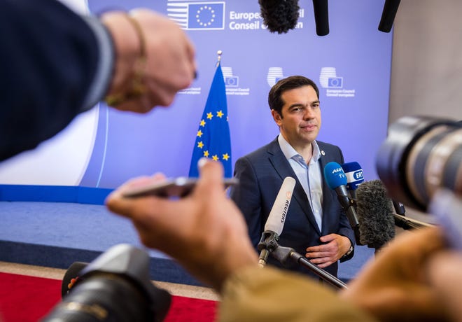 Greek Prime Minister Alexis Tsipras speaks with the media after a meeting of eurozone heads of state at the EU Council building in Brussels on Monday. A summit of eurozone leaders reached a tentative agreement with Greece on Monday for a bailout program that includes "serious reforms" and aid, removing an immediate threat that Greece could collapse financially and leave the euro. AP Photo/Geert Vanden Wijngaert