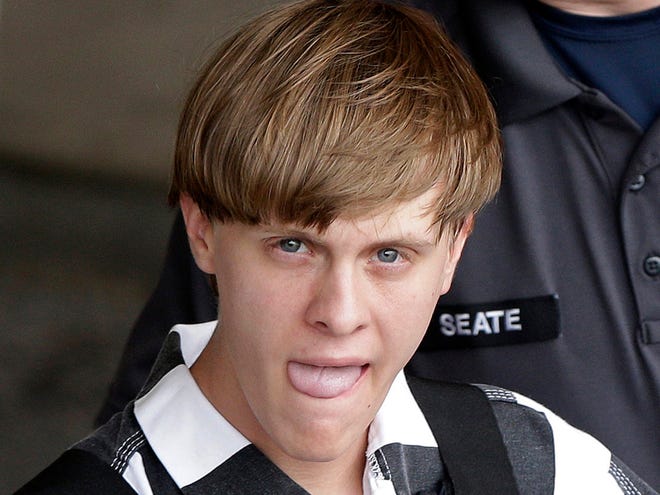 In this June 18, 2015 file photo, Charleston, S.C., shooting suspect Dylann Storm Roof is escorted from the Cleveland County Courthouse in Shelby, N.C. A jail clerk made a mistake when entering information about a drug arrest for church shooting suspect Roof, the first in a series of missteps that allowed Roof to purchase a gun he shouldn't have been able to buy two months before the attack, authorities said.