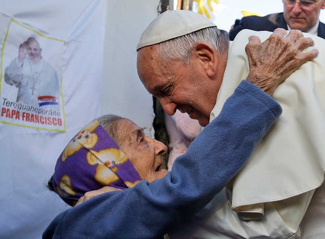 Gregorio Borgia/The Associated PressPope Francis is greeted by a woman on Sunday during his visit to the Banado Norte neighborhood in Asuncion, Paraguay.