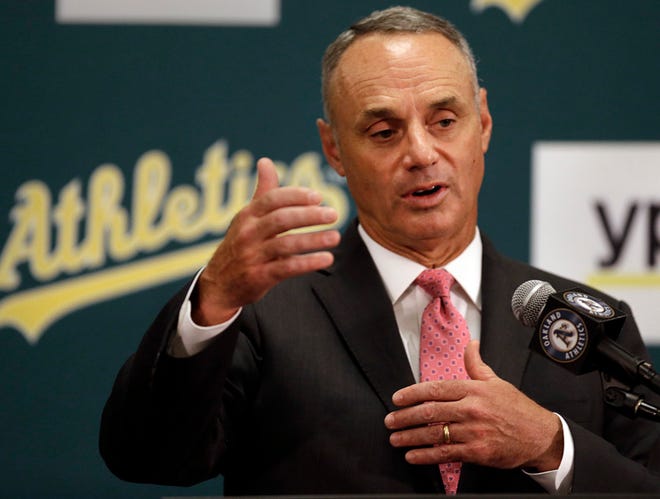 Baseball Commissioner Rob Manfred gestures during a media conference Friday, June 19, 2015, prior to a baseball game between the Los Angeles Angels and the Oakland Athletics in Oakland, Calif.