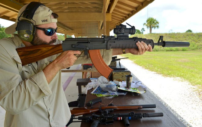 Brian Seidel, an AK enthusiast and avid hunter, wants to be able to hunt without earmuffs. He enlinsted friend and gunsmith Derrick Dumont to solve the problem of suppressing an AK. Here, Seidel shoots a suppressed Century Arms c39 v1 at Knights Trail Gun Range. STAFF PHOTO / MIKE LANG