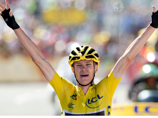 Britain's Christopher Froome, wearing the overall leader's yellow jersey, celebrates as he crosses the finish line to win the tenth stage of the Tour de France cycling race over 167 kilometers (103.8 miles) with start in Tarbes and finish in La Pierre-Saint-Martin, France, Tuesday, July 14, 2015.