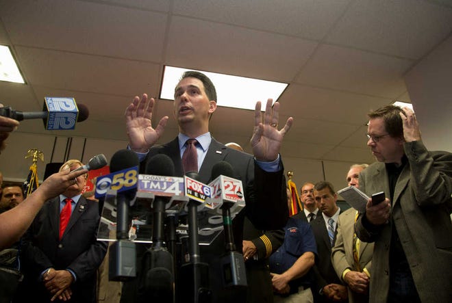 Associated Press file photoWisconsin Gov. Scott Walker speaks last month after signing a bill at the Milwaukee County Sheriff's office that eliminates a 48-hour waiting period for handgun purchases.