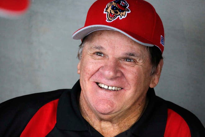 Pete Rose visits with members of the Washington Wild Things in their dugout before a Frontier League baseball game against the Lake Erie Crushers in Washington, Pa, Tuesday, June 30, 2015. Rose coach each baseline for a half inning for the Wild Things after which fans could pay for an autograph and to have their picture take with him. (AP Photo/Gene J. Puskar)