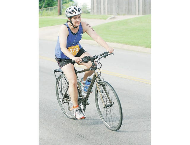 Bartlesville’s Michelle Green makes the turn out of Sooner Park during the bike riding portion of last Saturday’s Bartlesville Triathlon: Tri to Stop Seizures. With a time of 1:42.55, Green finished 52nd overall and 12 among the females. The events included a 400m swim, 12-mile bike ride and 3.1-mile run. Mike Tupa/Examiner-Enterprise 
 Bartlesville’s Michelle Green makes the turn out of Sooner Park during the bike riding portion of last Saturday’s Bartlesville Triathlon: Tri to Stop Seizures. With a time of 1:42.55, Green finished 52nd overall and 12 among the females. The events included a 400m swim, 12-mile bike ride and 3.1-mile run. Mike Tupa/Examiner-Enterprise 
 Bartlesville’s Michelle Green makes the turn out of Sooner Park during the bike riding portion of last Saturday’s Bartlesville Triathlon: Tri to Stop Seizures. With a time of 1:42.55, Green finished 52nd overall and 12 among the females. The events included a 400m swim, 12-mile bike ride and 3.1-mile run. Mike Tupa/Examiner-Enterprise