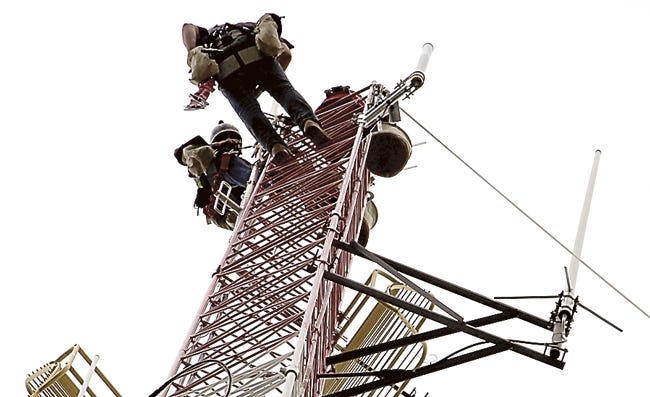 Senior climber Chris Strouse and his work partner, Coord Welch, of JT Tower Service, spent the better part of the day Tuesday atop the St. Joseph County E-911 Central Dispatch communications tower in Centreville. Work started Monday and is expected to conclude today.