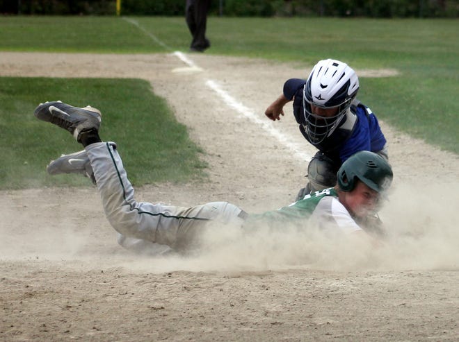 Dover's Egan Paoletti, bottom, beats the tag of Hampton catcher Kai Nichols during District A tournament action on Tuesday in Rochester. John Doyle/Fosters.com