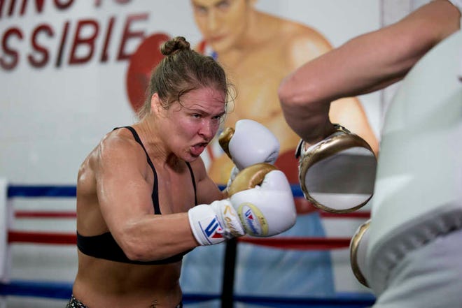 MMA fighter Ronda Rousey trains with trainer Edmond Tarverdyan at Glendale Fighting Club on Wednesday in Glendale, Calif. Rousey, the UFC bantamweight champion, will return to the octagon against Brazil's unbeaten Bethe Correia at UFC 190 in Rio de Janeiro on Aug. 1. (AP Photo/Jae C. Hong)