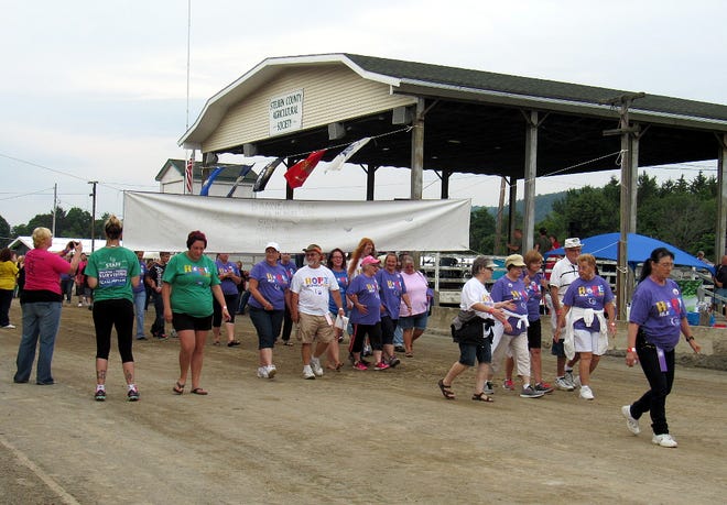 Cancer survivors and caregivers take part in the first lap of the Bath-Hammondsport Relay for Life Friday night. James Post/The Leader
