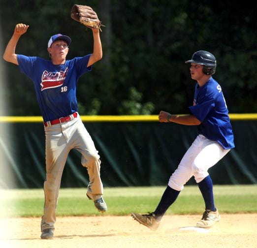 Caldwell County's Holden Triplett jumps up for the ball as Shelby's Nate Blanton makes it to safe to second during their Junior Tar Heel League state tournament game at Shelby City Park on Friday.