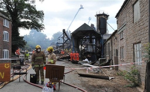 Search and rescue teams from all emergency services search the scene of an explosion and fire where four people are still missing at in Bosley, Cheshire northern England Saturday July 18, 2015. The explosion took place at the wood treatment plant on Friday (Chris Neil/Sunday Telegraph/PA via AP)