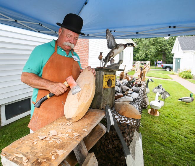 Dave Weber demonstrates the art of decoy carving and, "roughing out the blank" which will end up being a goose decoy on Saturday at the Hampton Historical Society's 90th Birthday Party on the grounds of the Tuck Museum. Matt Parker Photos
