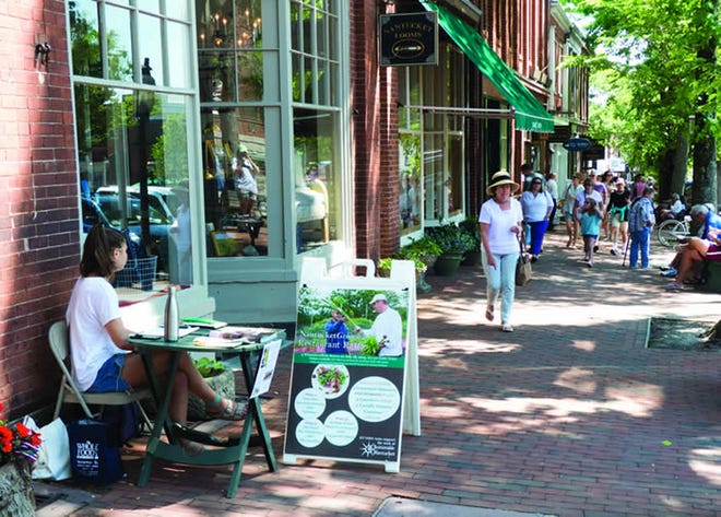 This year the Nantucket Historic District Commission began cracking down on the use of so-called sandwich boards, as shown here for a Sustainable Nantucket raffle. The signs are prohibited by the commission, but the law has not been enforced until now, with police notifying offenders that they need to remove their signs or face stiff daily fines. Nicole Harnishfeger/Inquirer and Mirror
