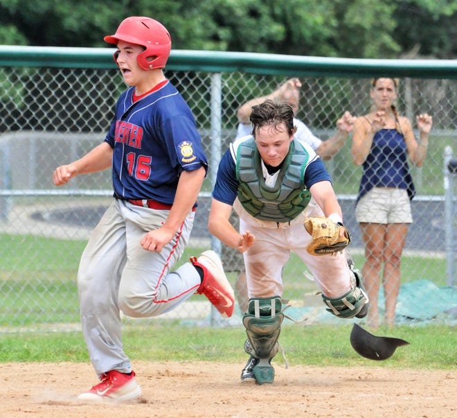 Rochester’s Christian Dow, left, beats Dover catcher Tim Verrill to the plate during Senior Legion District B action Sunday in Dover. MIKE WHALEY/FOSTERS.COM