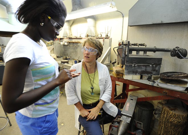 Dorean Asuako, 15, talks with program coordinator K.C. Murphy during a jewelry-making segment of a STEM Teaching and Learning Program held recently at the Worcester Center for Crafts. T&G Staff/Christine Hochkeppel