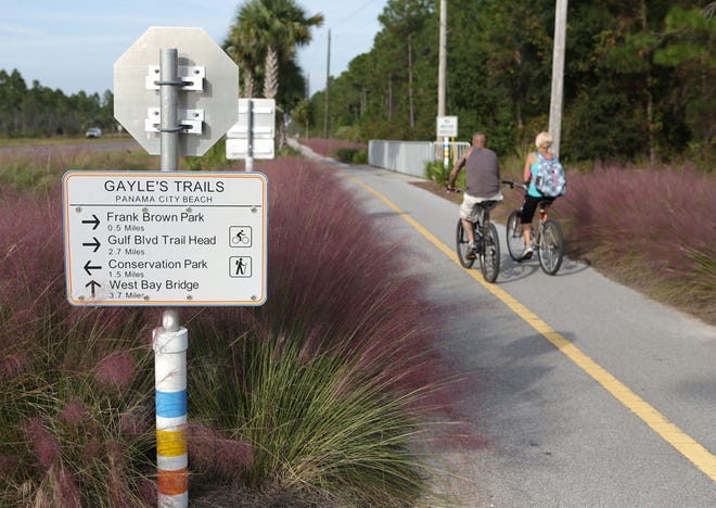 A couple bikes Gayle's Trails in Panama City Beach. The state is looking to expand the state's trails system, of which Gayle's Trails is a part.
