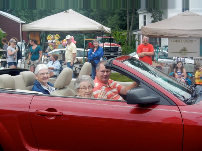 Martha Roberts, Alfred's oldest resident, waves as she leads the Grand Parade through Alfred village on Saturday, July 18. PHOTO BY PENNY MILLS