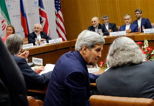 FILE - In this July 14, 2015 file pool photo, Secretary of State John Kerry, talks with Energy Secretary Ernest Moniz, as Iranian Foreign Minister Mohammad Javad Zarif background second left, sits next to European Union High Representative for Foreign Affairs and Security Policy Federica Mogherini, during a plenary session at the United Nations building in Vienna, Austria. The U.N. Security Council is set to endorse the landmark nuclear deal on Monday, July 20, between Iran and six world powers and adopt a series of measures leading to the end of U.N. sanctions that have hurt the Iranian economy.